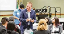  ?? ?? Ryan Hawk, executive director of business developmen­t and community outreach at Peach State Federal Credit Union, speaks with Georgia Gwinnett College students as part of Tuesday’s networking event for Latino students.