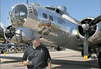  ?? Darrell Sapp/Post-Gazette ?? Pilot John Shuttlewor­th of Ft. Wayne, Ind., talks in front of the Madras Maiden B-17 on Monday at the Allegheny County Airport in West Mifflin. The B-17s and the young men who flew in them made sacrifices that ensured “our freedoms and our way of...