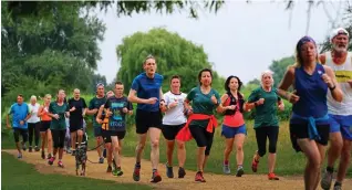  ?? ?? Fun way to fitness: Runners take part in a Parkrun in Bushy Park, London