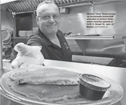  ?? GARY SEMAN JR. ?? Mentor "Tony" Rama serves up housemade buttermilk pancakes at Zorba's Diner, which recently opened at 3415 E. Broad St. east of Bexley.