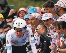  ?? Philippe Lopez / AFP via Getty Images ?? Defending Tour de France champion Tadej Pogacar of Slovenia speeds by spectators on his way to winning the Stage 5 time trial.