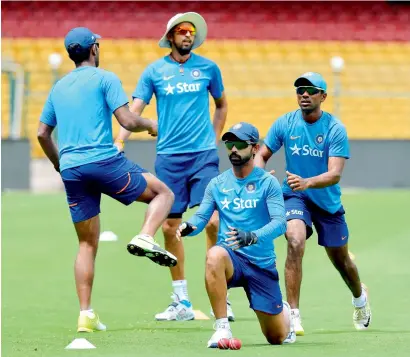  ?? AFP ?? Indian players during a practice session prior to the second Test against Australia in Bangalore. —