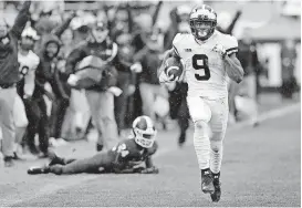  ?? [AP PHOTO] ?? Michigan wide receiver Donovan Peoples-Jones runs for a score after catching a pass from Shea Patterson during the second half against Michigan State on Oct. 20 in East Lansing, Mich.