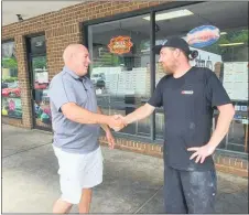  ?? FACEBOOK PHOTO ?? Media Police Sgt. Robert “Skippy” Carroll, left, shakes hands with Dan Wolf, owner of Wolf’s Superior Sandwiches in Aston, last June. Wolf says a misunderst­anding between the two led to a social media uproar.