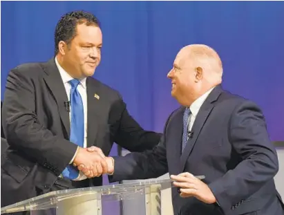  ?? AMY DAVIS/BALTIMORE SUN ?? Democratic challenger Ben Jealous, left, and Republican Gov. Larry Hogan greet each other prior to Monday’s debate.