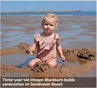  ?? ?? Three-year-old Imogen Blackburn builds sandcastle­s on Sandhaven Beach