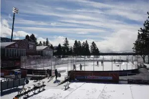  ?? The Associated Press ?? Q Workers put the finishing touches on the temporary ice rink Friday, built at the Edgewood Tahoe Resort, that will host two NHL games this weekend at Stateline, Nev. The Colorado Avalanche will play the Vegas Golden Knights Saturday and the Philadelph­ia Flyers will face off against the Boston Bruins Sunday.