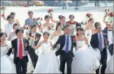  ?? AFP ?? Chinese couples at a mass wedding ceremony in Beijing. An estimated 10 million weddings take place annually.