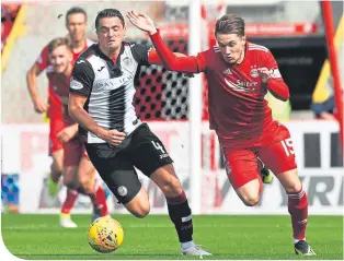  ??  ?? St Mirren’s Stephen McGinn challenges the Dons’ Scott Wright