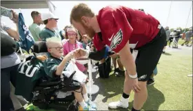  ?? MATT ROURKE - THE ASSOCIATED PRESS ?? Philadelph­ia Eagles quarterbac­k Carson Wentz bumps fists with eleven-year-old Giovanni Hamilton who is attending the practice as part of a wish granted by Bianca’s Kids at the NFL football team’s training camp in Philadelph­ia, Friday, July 26, 2019.