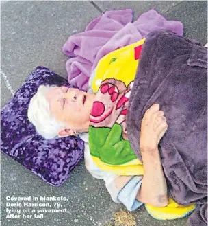  ?? Picture: KATE McMULLIN ?? Covered in blankets, Doris Harrison, 79, lying on a pavement after her fall