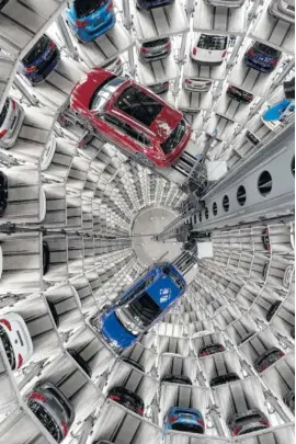  ?? THE ASSOCIATED PRESS ?? Volkswagen cars are lifted inside a delivery tower of the company in Wolfsburg, Germany, on Tuesday.