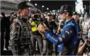  ?? Chris O'Meara/Associated Press ?? Jimmie Johnson, right, and Travis Pastrana talk before qualifying for the NASCAR Daytona 500 auto race Wednesday at Daytona Internatio­nal Speedway in Daytona Beach, Fla.