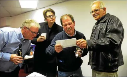  ?? TANIA BARRICKLO — DAILY FREEMAN ?? Checking election results Tuesday night at Democratic headquarte­rs on Broadway in Kingston are from left, Kingston Common Council President James Noble, Ulster County Legislatur­e candidate Lynn Eckert of Kingston, city Democratic Chairman Committee...