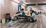  ?? Photos: Ben Marans, Edmond So ?? Volunteers with ImpactHK visit a homeless man in a Causeway Bay subway on a recent Sunday.