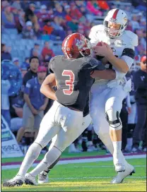  ?? ANDRES LEIGHTON/THE ASSOCIATED PRESS ?? Louisiana-Monroe QB Pete Thomas, right, is tackled by NMSU linebacker Derek Ibekwe during the Warhawks’ 30-17 win.