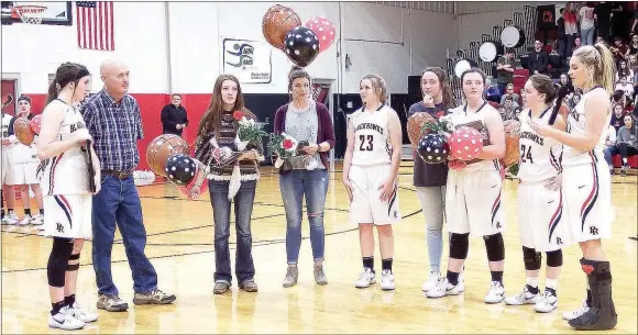  ?? TIMES photograph by Annette Beard ?? Senior Lady Blackhawk basketball players honored former basketball coach Larry Walker on their senior night.
