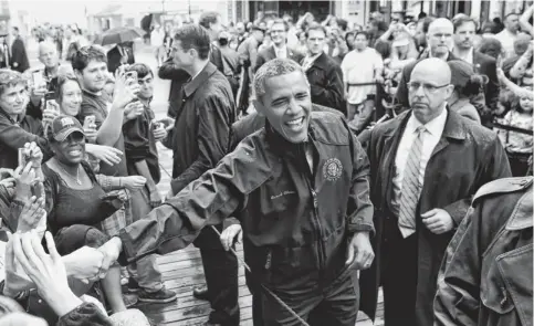  ?? SAUL LOEB, AFP/GETTY IMAGES ?? The “boardwalk bromance” may have cooled (no hugs this time between the bipartisan duo) as President Obama tours Point Pleasant, N.J.