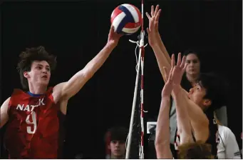  ?? CHRIS CHRISTO — BOSTON HERALD ?? Natick’s Nicholas Bonavire, left, lifts the ball over Newton North defenders at the net in Natick’s 3-1 win.