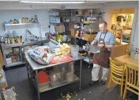  ?? LLOYD FOX/BALTIMORE SUN ?? Stephen Wittstadt peels and prepares potatoes at the cafe. He is a prep cook who mastered some of his skills by practicing at home.