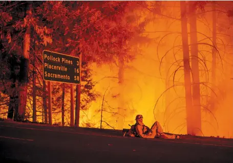  ??  ?? A firefighte­r taking a break from battling the King Fire, Fresh Pond, California, September 2014