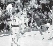  ?? TONY GUTIERREZ AP ?? Mavericks guard Luka Doncic shoots a 3-point basket over the stretched arms of Warriors forward Andrew Wiggins.