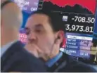  ?? Richard Drew, The Associated Press ?? Traders work on the floor of the New York Stock Exchange on Thursday, when the Dow Jones fell more than 700 points because of trade fears.