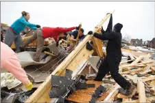  ?? AP PHOTO ?? Residents help collect clothing and look for pets at a destroyed home Sunday after a fierce storm hit Saturday in the Farmington subdivisio­n in Clarksvill­e, Tenn.