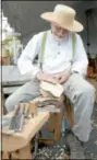  ??  ?? John Munro carves a wooden spoon farm house style
during the Apple Butter
Frolic.