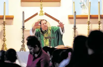  ?? Elizabeth Conley / Staff photograph­er ?? The Rev. Jeffrey David Newell, accused of abuse, blesses kids during Mass at Our Lady of the Incarnatio­n in Tijuana in November.