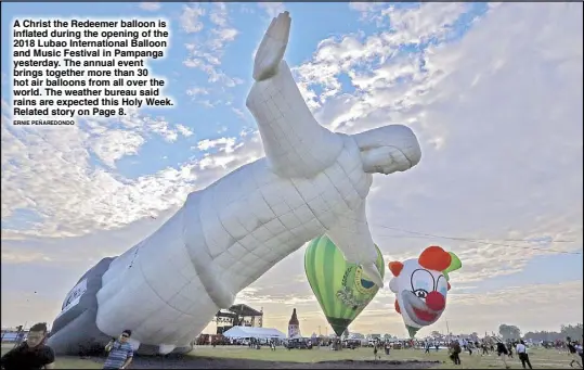  ?? ERNIE PEÑAREDOND­O ?? A Christ the Redeemer balloon is inflated during the opening of the 2018 Lubao Internatio­nal Balloon and Music Festival in Pampanga yesterday. The annual event brings together more than 30 hot air balloons from all over the world. The weather bureau said rains are expected this Holy Week. Related story on Page 8.