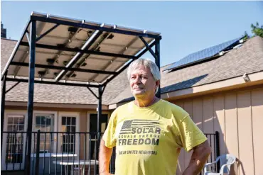  ?? Lola Gomez/dallas Morning NEWS/TNS ?? ■ Larry Howe, co-founder of Plano Solar Advocates, installed solar panels on his roof and over his backyard porch. He said the panels provide about 60% of his yearly electricit­y.