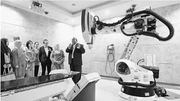  ??  ?? Rohani (second right) and others being briefed by Dr Mohamed Ibrahim (right) about a CyberKnife System Delivery treatment machine for patients during the Launching of RM2 Million Breast Cancer Chemothera­py Fund yesterday. — Bernama photo