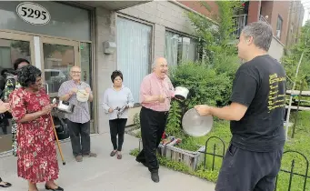  ?? JOHN MAHONEY/ THE GAZETTE ?? Social housing activist Jean-Philippe Tremblay, right, leads residents during a demonstrat­ion against new provincial regulation­s.