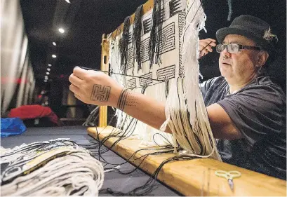  ?? ADRIAN LAM, TIMES COLONIST ?? Artist Willliam White, a member of the Tsimshian people, weaves a dancing apron at the Royal B.C. Museum.