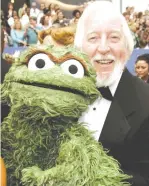  ?? (Reuters) ?? CAROLL SPINNEY, the puppeteer and voice of muppets on TV’s ‘Sesame Street,’ poses with Oscar the Grouch in 2006.