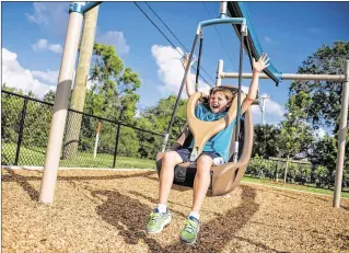  ?? MICHAEL ARES / THE PALM BEACH POST ?? Jeremy Scott, 8, rides a zip line at the Ironwood Park in Palm Beach Gardens. The zip lines are accessible to children with and without disabiliti­es. City Councilman Carl Woods pushed for the park as the start of a beautifica­tion project for the...