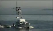  ?? ROBERT F. BUKATY — THE ASSOCIATED PRESS ?? A fishing boat equipped with a tuna tower motors out of Casco Bay in South Portland, Maine. The extra elevation of the tower helps fishermen to spot tuna moving near the water’s surface.