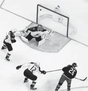  ?? Jay LaPrete, The Associated Press ?? Columbus’ Thomas Vanek scores a second-period goal against Colorado goaltender Semyon Varlamov during Thursday night’s game in Columbus, Ohio. The Avalanche lost in overtime. Vanek scored twice and had a game-high eight shots. Varlamov made 39 saves.