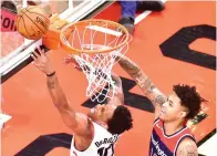  ?? Frank Gunn/The Canadian Press
via AP ?? ■ Toronto Raptors guard DeMar DeRozan (10) attempts a layup as Washington Wizards forward Kelly Oubre Jr. defends during the first half of Game 2 of an NBA first-round playoff series Tuesday in Toronto.