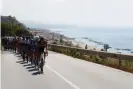  ?? Luca Bettini/AFP/Getty Images ?? The peloton rides along Sicily’s northeaste­rn coastline during stage five. Photograph: