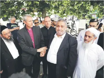  ??  ?? Local faith leaders stand together as they pose for photograph­ers, near Finsbury Park Mosque, in a show of friendship following the attack outside the mosque, in London, Britain. — Reuters photo