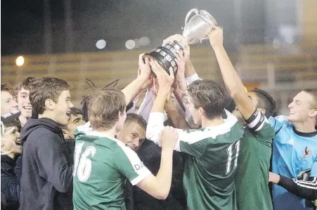  ??  ?? Oak Bay players hoist the Colonist Cup after their win over Reynolds at Centennial Stadium on Thursday.