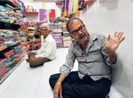  ??  ?? A TEXTILE MERCHANT’S shop in Surat, a file photograph. The thriving textile trade of Surat has virtually come to a halt amid the COVID-19 crisis as it deals with reduced demand and a shortage of labour.