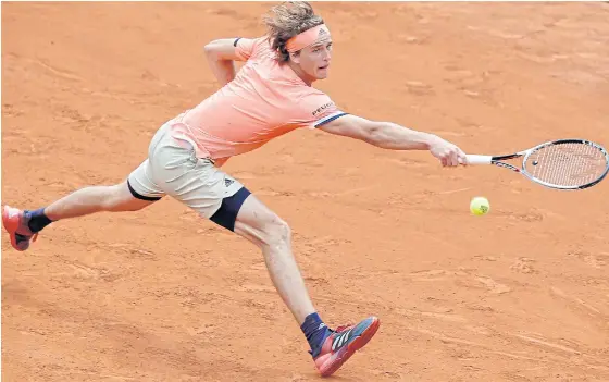  ??  ?? Alexander Zverev stretches for a backhand return during his third round match against Damir Dzumhur at Roland Garros.