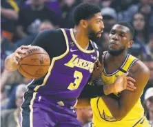  ?? Scott Strazzante / The Chronicle ?? Warriors forwardcen­ter Kevon Looney defends against the Lakers’ Anthony Davis at Chase Center on Feb. 27.