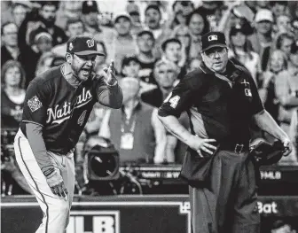  ?? Karen Warren / Staff photograph­er ?? The Nationals, including manager Dave Martinez, sought answers from umpire Sam Holbrook. Martinez was ejected after the call was reviewed and upheld.