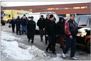  ?? AP/MATT MARTON ?? Employees are escorted Friday from the scene of the shooting at a manufactur­ing plant in Aurora, Ill.