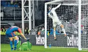  ??  ?? Slap in the goalmouth: Jamie Vardy hits the bar in frustratio­n after his shot struck the post following Palace goalkeeper Vicente Guaita’s superb save