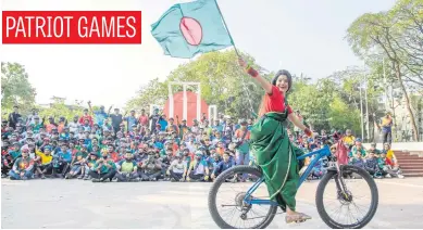  ?? Picture: EPA-EFE ?? A cyclist with a national flag during the celebratio­n of Bangladesh’s 54th Independen­ce Day in Dhaka yesterday. It became independen­t after victory in the War of Liberation against Pakistan.